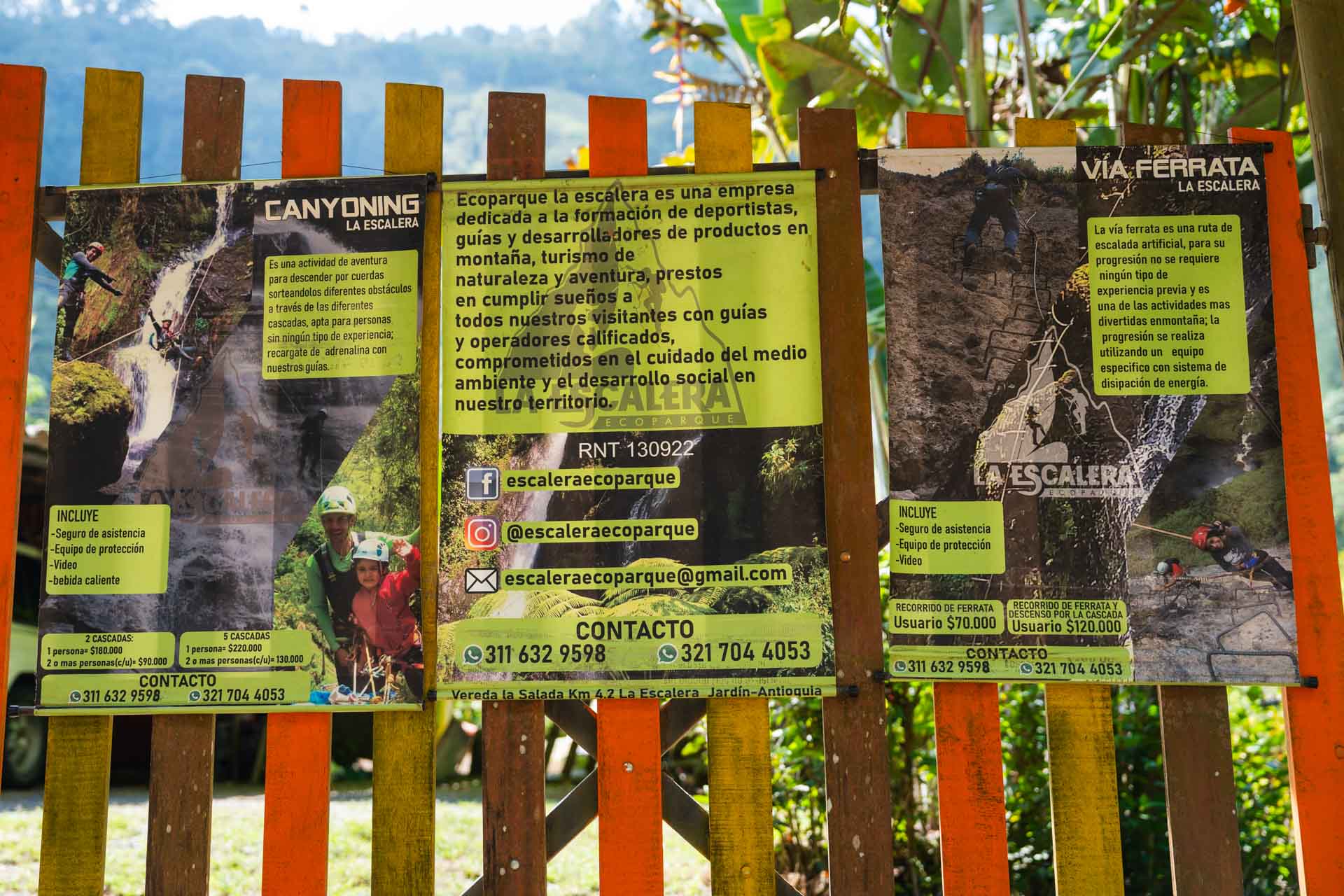 Canyoning information posters on a fence at Cascada la Escalera.