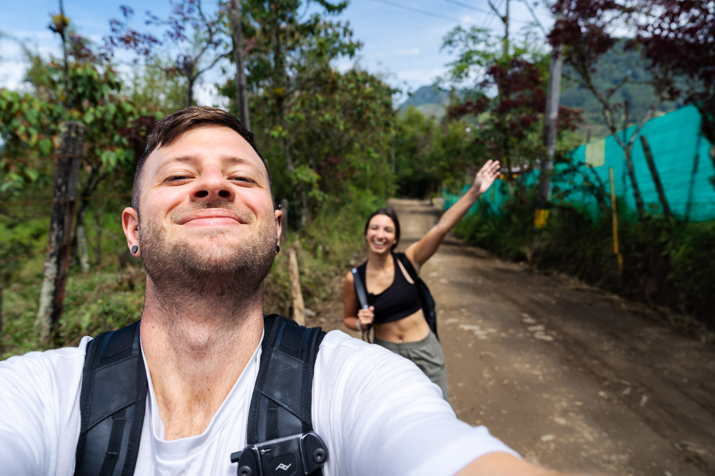 A selfie of Ryan and Sara walking along a mud road on the Camino de la Herrera.
