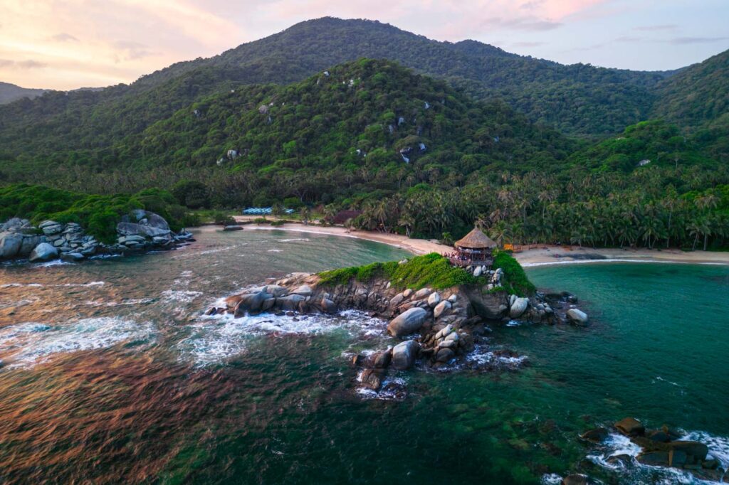 Sunrise tones over the forests and beach of Cabo San Juan in Tayrona National Park.