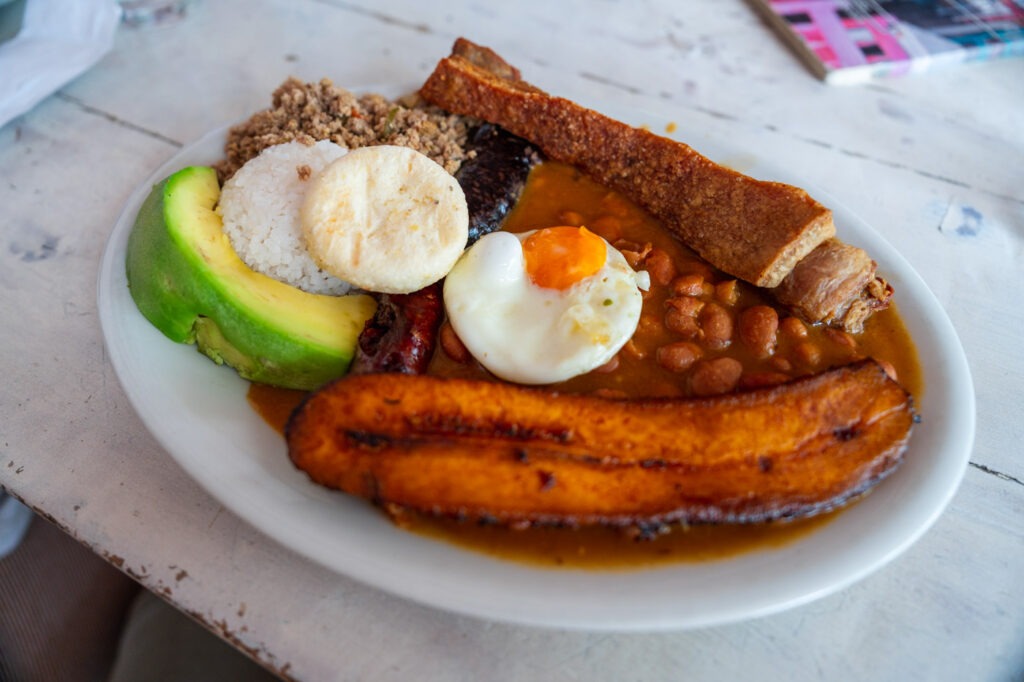 A typical Colombian bandeja paisa meal with plantain, egg, chorizo, avocado and more.