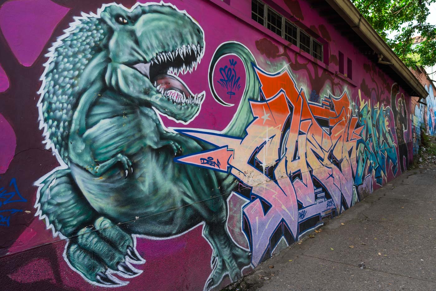 Dinosaur themed street art in Comuna 13.