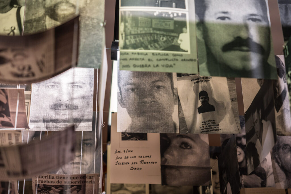 Newspaper articles about people going missing in Medellin hanging from the ceiling in Museo Casa de la Memoria.