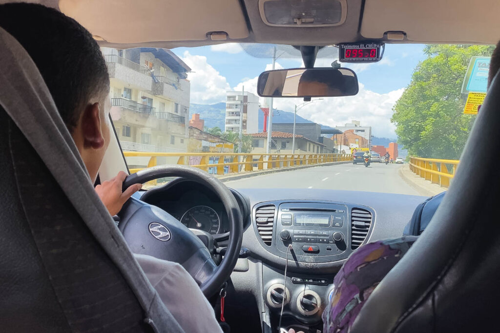 Ryan sitting inside a yellow taxi with the meter running in Medellin. Ryan sitting inside a yellow taxi with the meter running in Medellin.