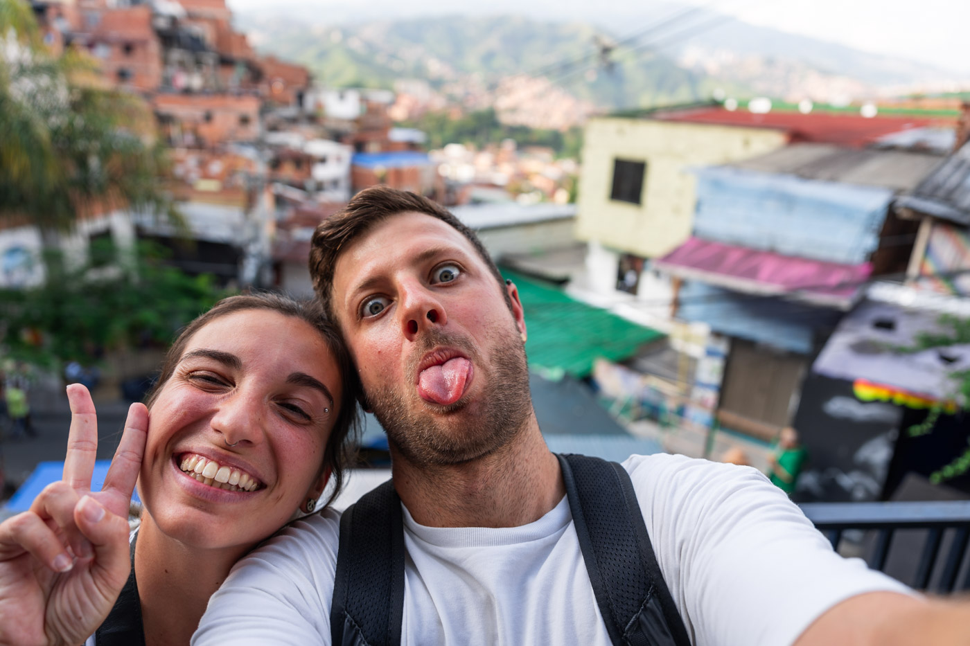 Ryan and Sara silly posing with a peace sign for a selfie in Comuna 13.