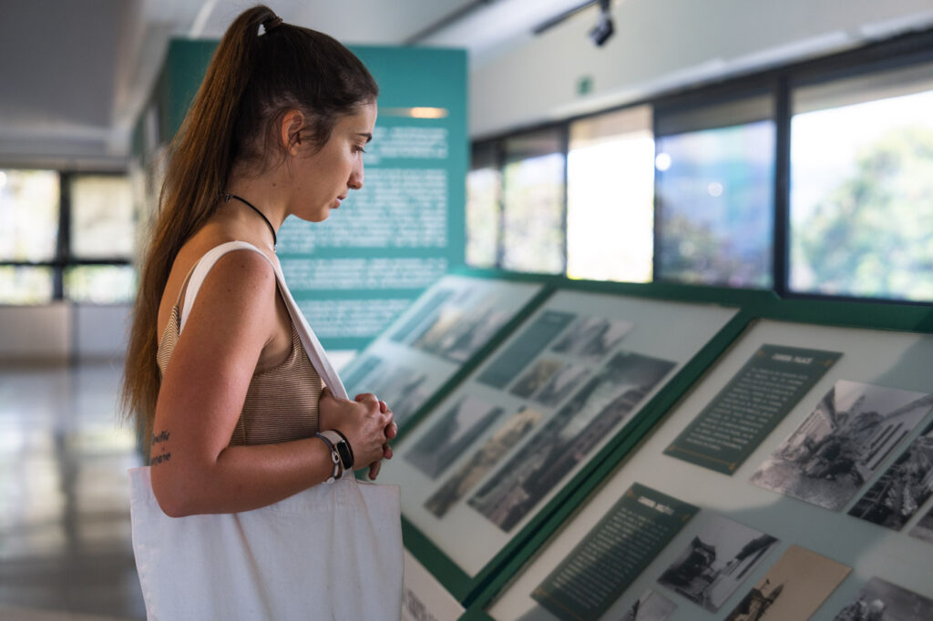 Sara reading the exhibit information inside the Museo de Ciudad in Medellin.