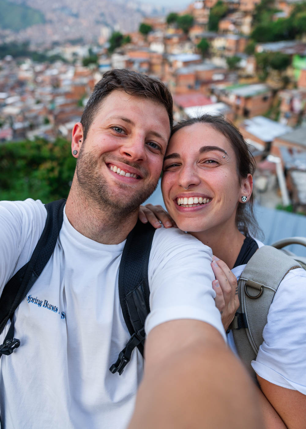 Sara and Ryan smiling while taking a selfie in comuna 13.