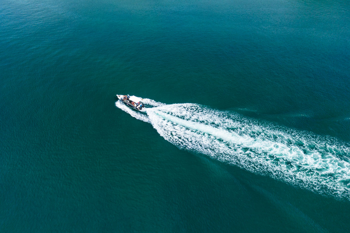 A small boat in the middle of the ocean.