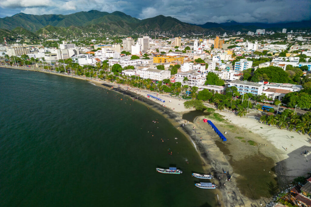 An aerial view across the white buildings of Santa Marta and it's beach.