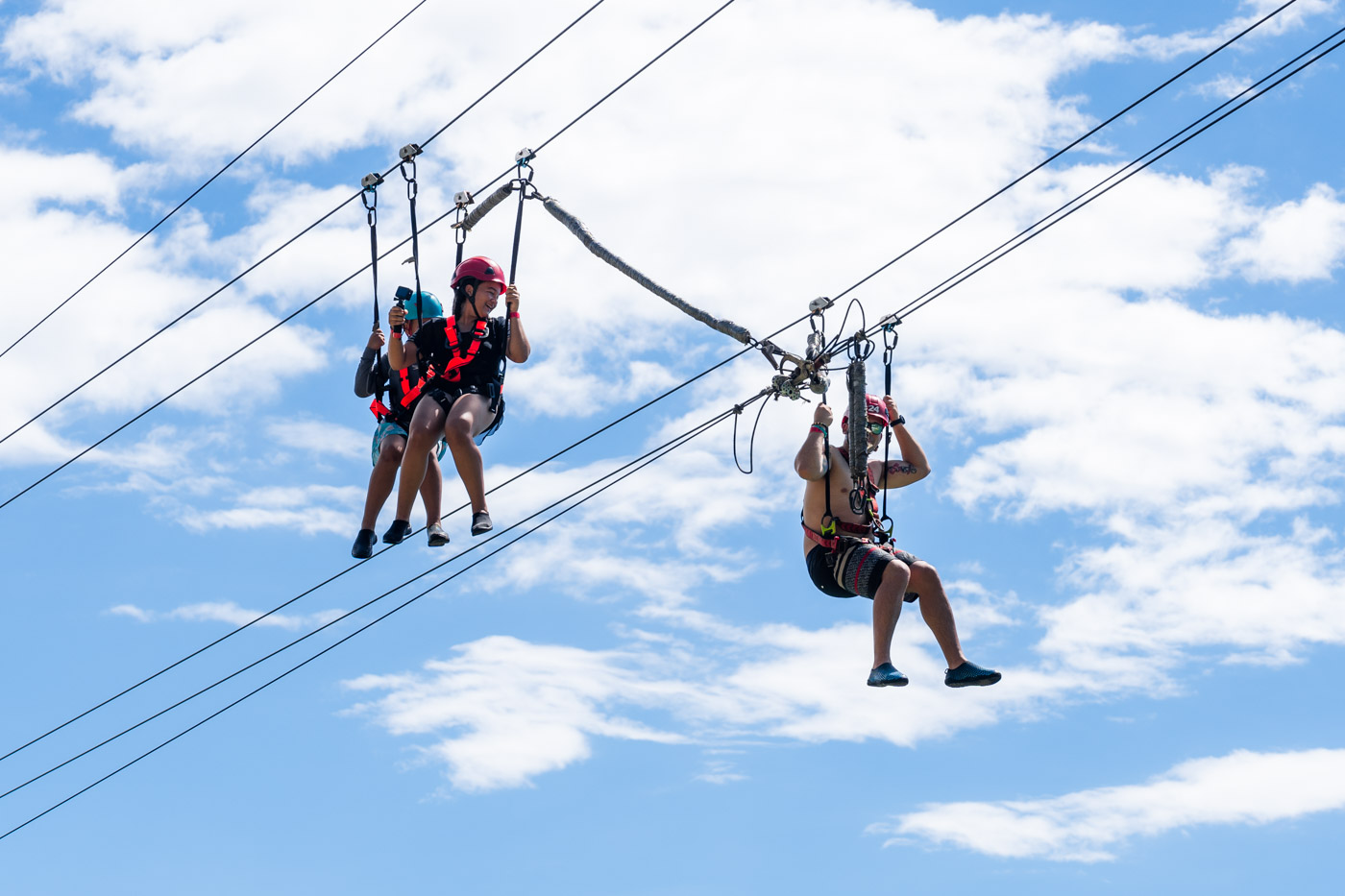 Three people on a zip line.