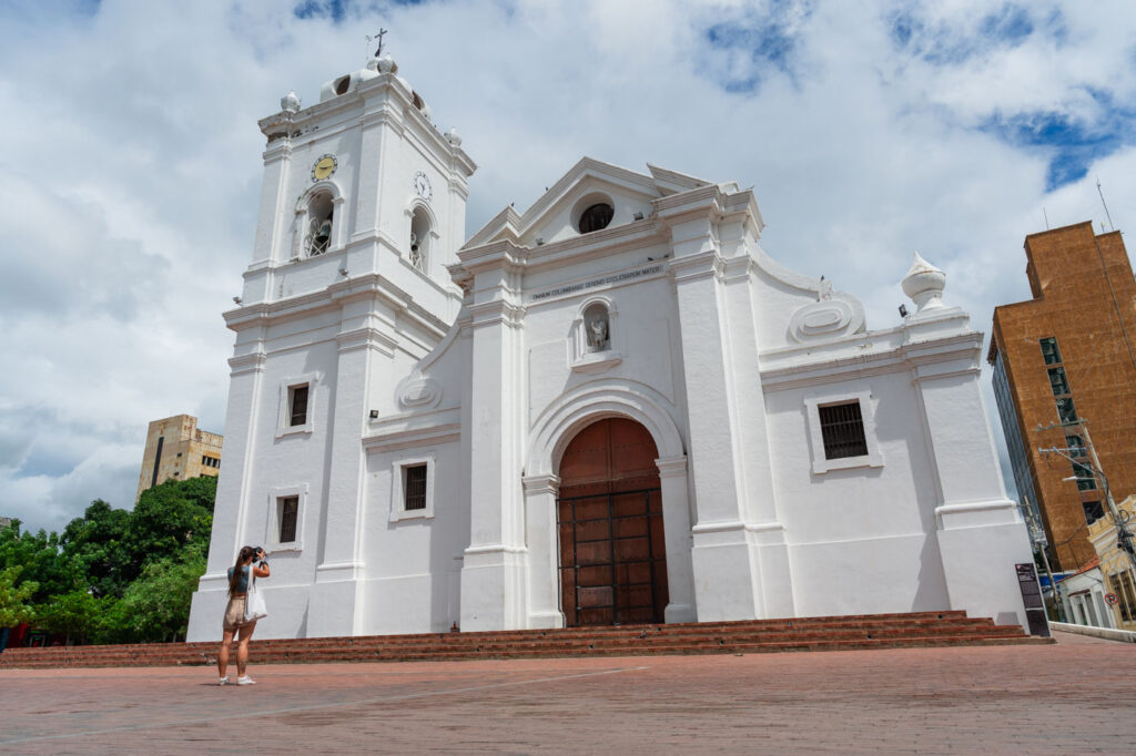 Sara taking photos of the exterior of Santa Marta's cathedral.