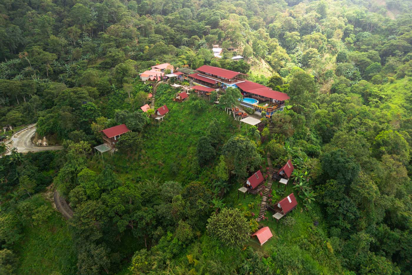 Aerial shot of Hostal Sierra Minca amongst the Colombia forest at sunrise.