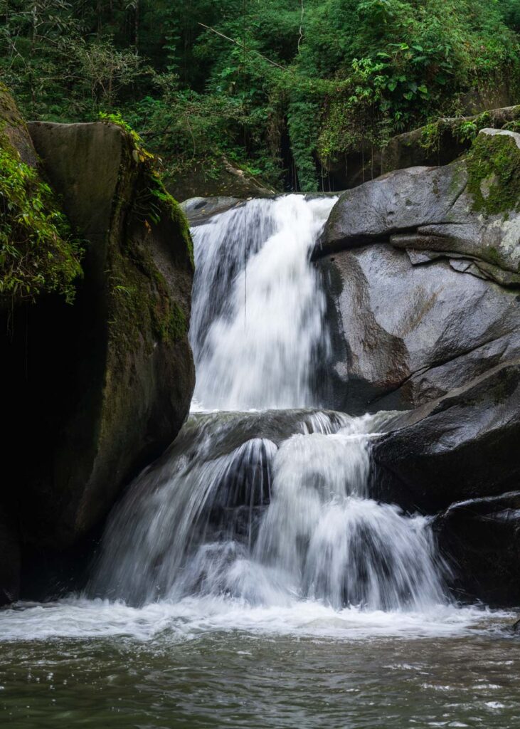 Long exposure of Cascada Oído del Mundo in the forest and framed by rocks. Long exposure of Cascada Oído del Mundo in the forest and framed by rocks.