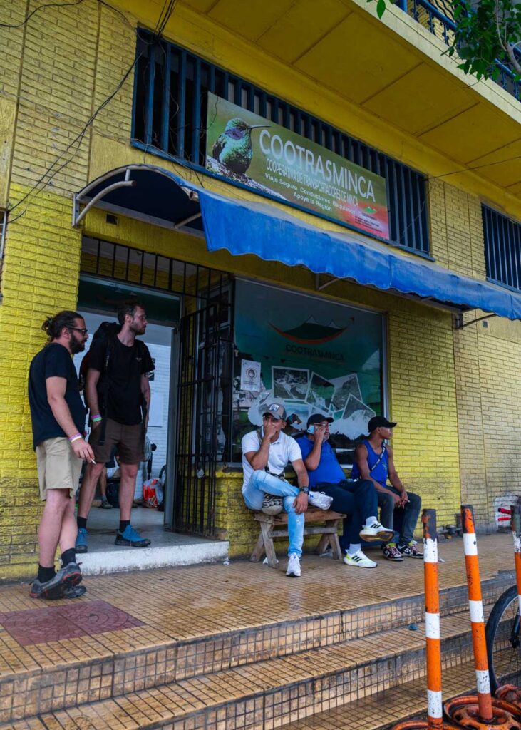People waiting outside the Cootrasminca bus service office in Santa Marta.