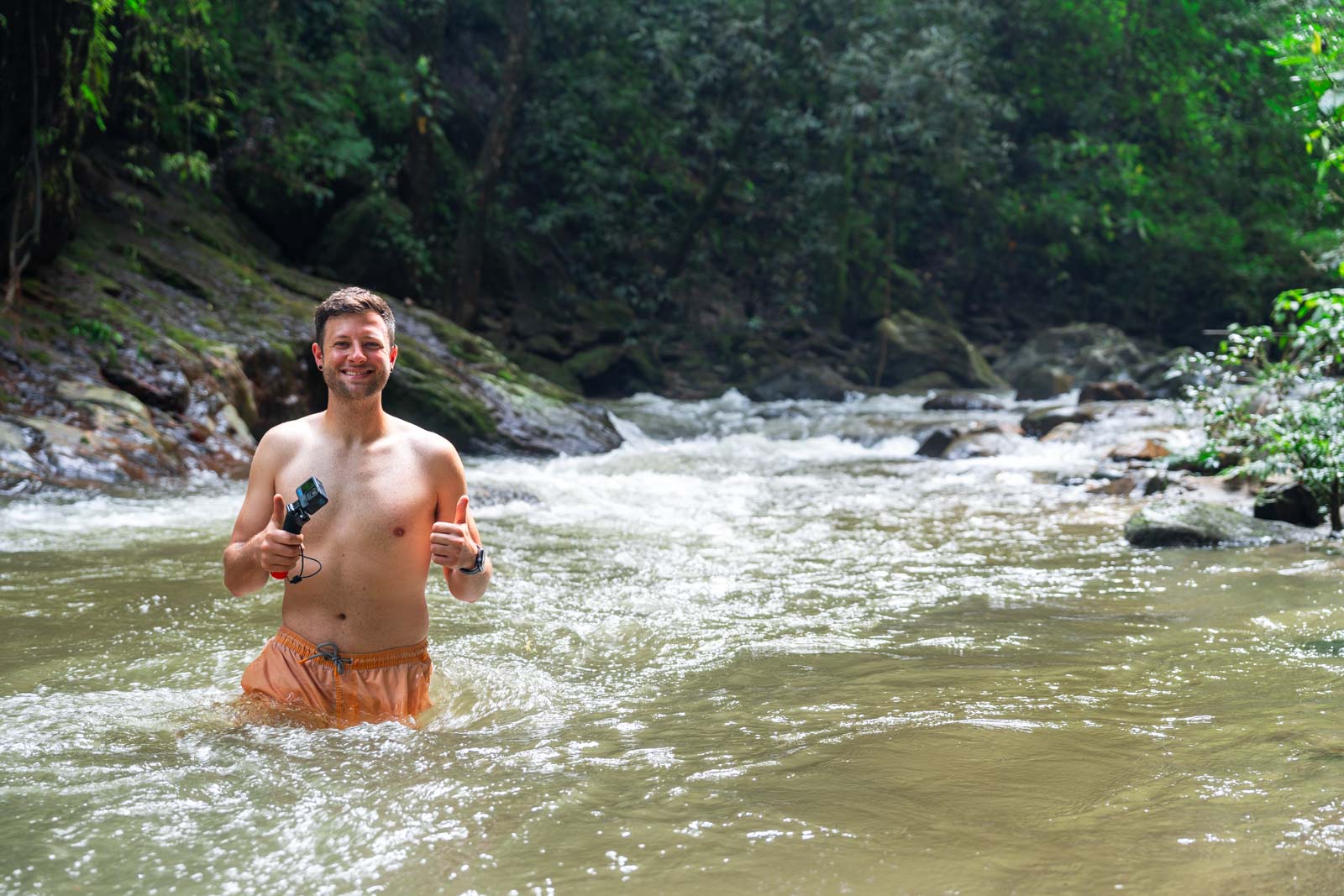Ryan waist deep in the river in the Minca forest close to Cascada Escondida.