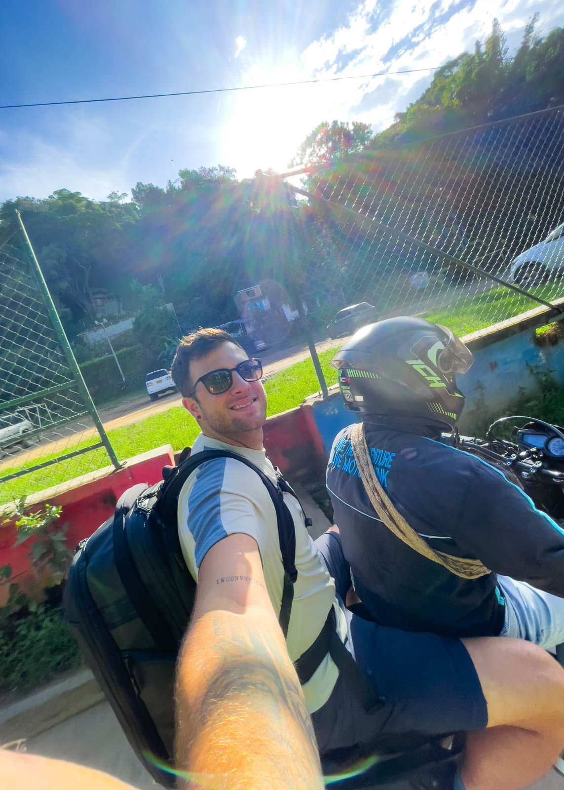 Ryan with a massive backpack on the back of a moto taxi in Minca.