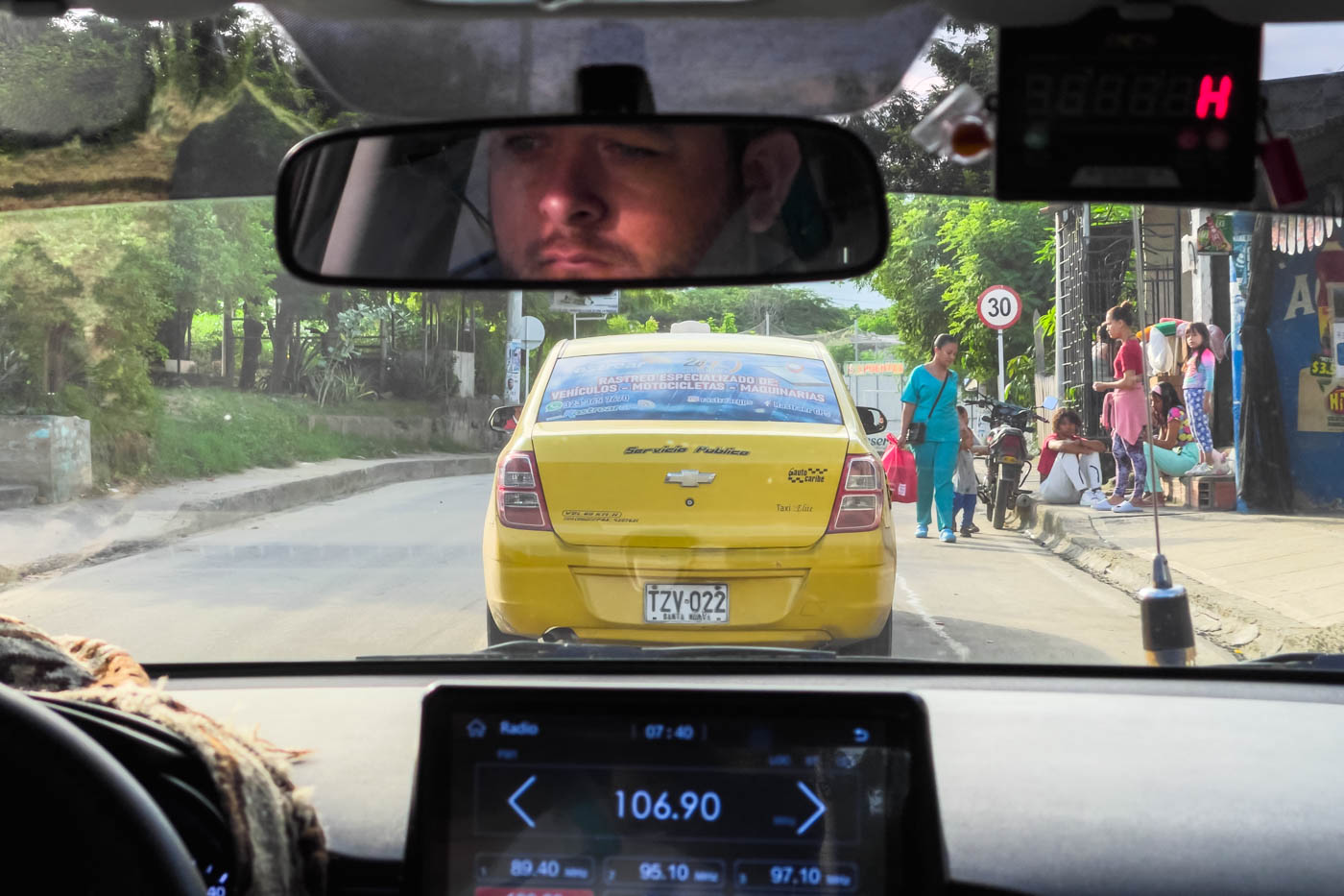 View out the front of the taxi looking at another yellow taxi driving from Santa Marta to Minca.