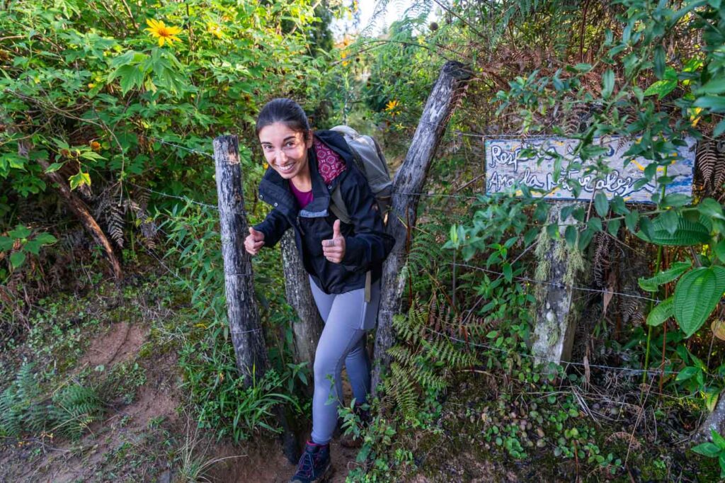Sara posing as she walks through a handmade gate along the Los Pinos Minca trail. Sara posing as she walks through a handmade gate along the Los Pinos Minca trail.