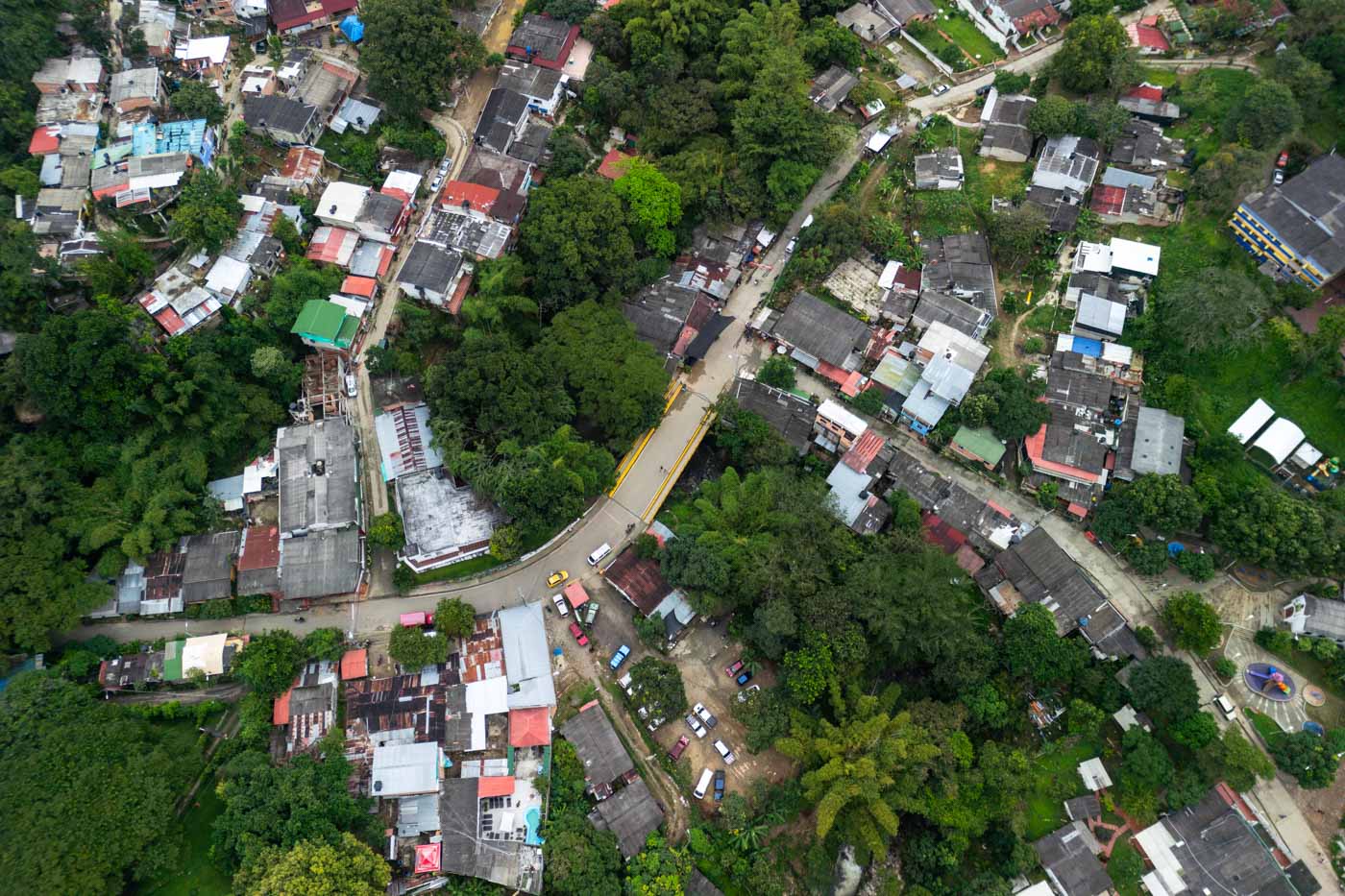 Aerial image over Minca village with a view of the bridge in the center and roads leading off of the main road.