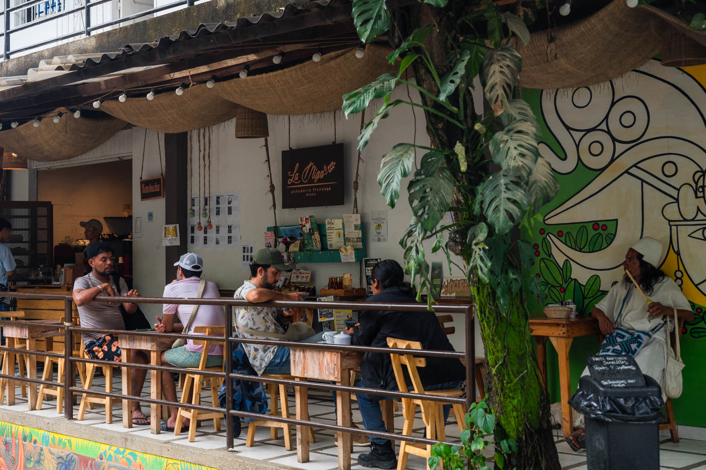 People sitting at the tables on the veranda of the La Miga Panaderia in Minca.