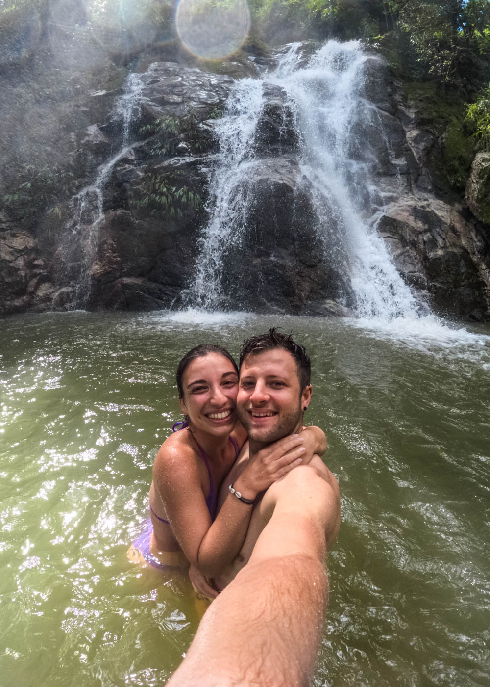 Ryan and Sara taking a selfie while swimming in front of the lower Marinka Waterfall.