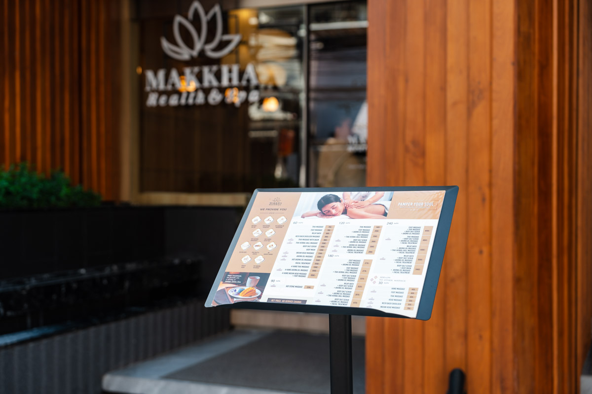 A list of services and prices for massages and spa treatments outside of Makkha Health & Spa in the Chiang Mai.